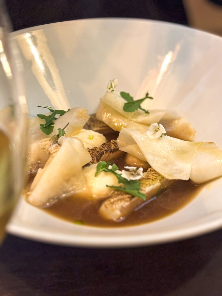 Une entrée à la présentation soignée posée sur la table au restaurant La Table des Poètes