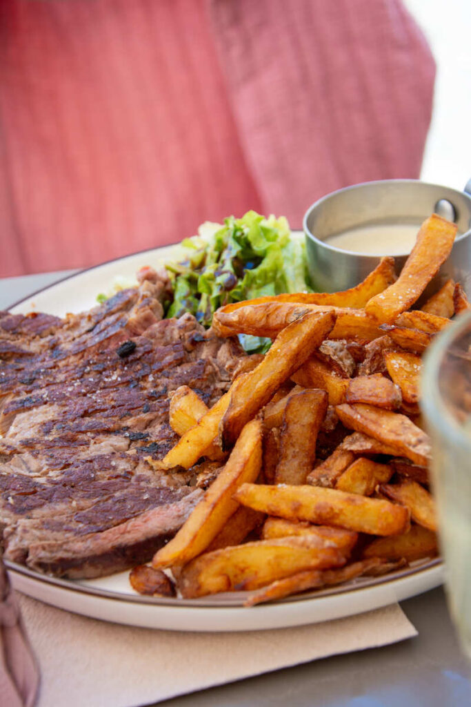 Un plat typique du restaurant L'Éminceur à Limoges avec une viande locale et des frites maison