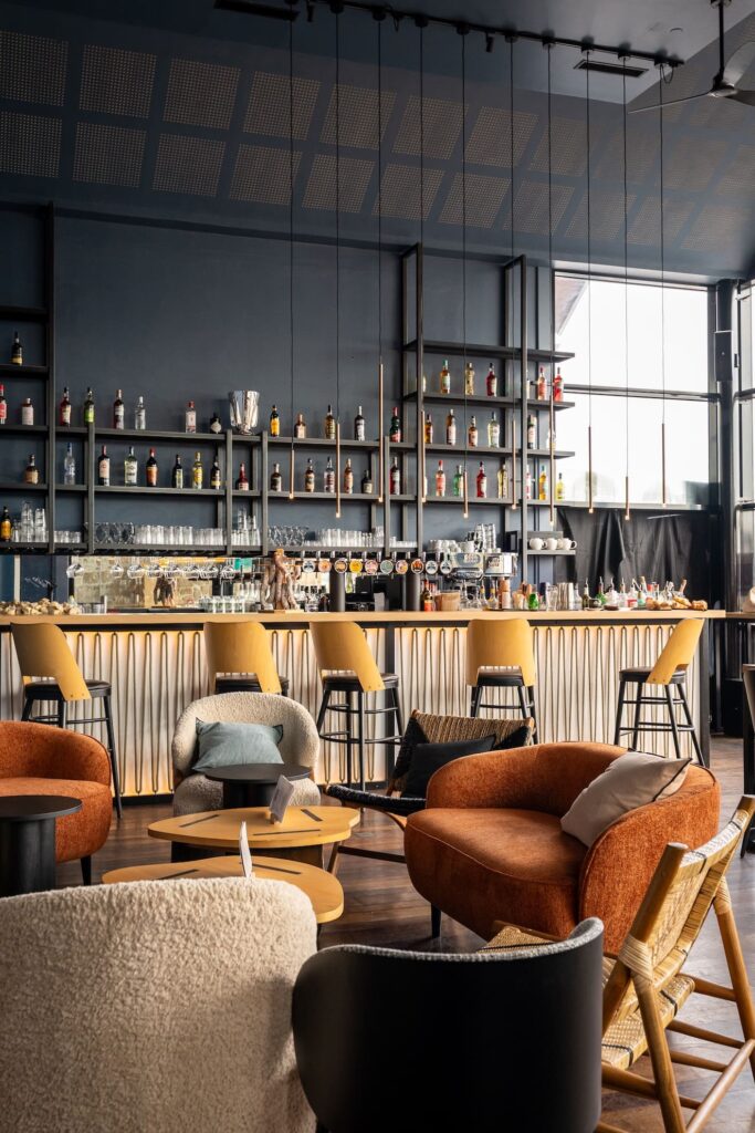 Salle lumineuse et colorée avec sièges variés aux Voiles de Solidor à Saint-Malo.