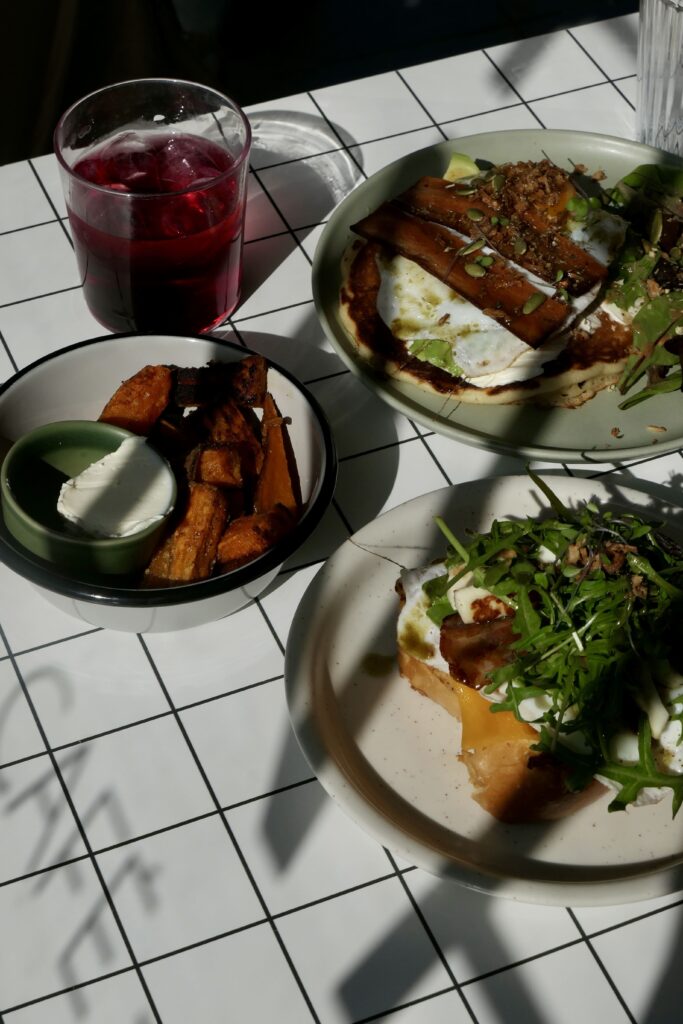 Assiettes sucrées et salées du coffee shop et brunch Hona à Biscarrosse-Plage. Brioche perdue salée, frites de patate douce et pancakes salés.
